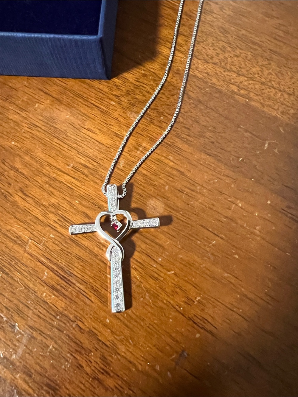 Silver Cross Necklace with Heart Accent and Red Stone